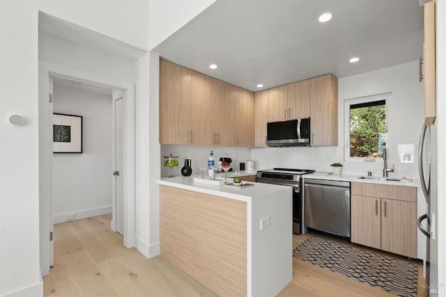 45 Harbor Oak Dr Unit 35, Tiburon, CA 94920 - kitchen with recessed lighting, a sink, light countertops, appliances with stainless steel finishes, and light wood-type flooring