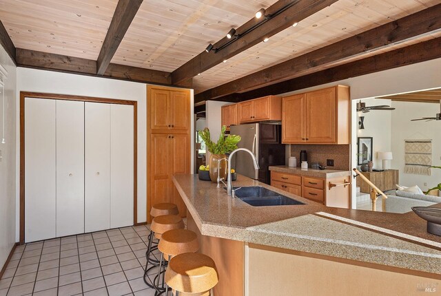 3651 Bones Rd, Sebastopol, CA 95472 - kitchen with a sink, beamed ceiling, freestanding refrigerator, decorative backsplash, and wood ceiling