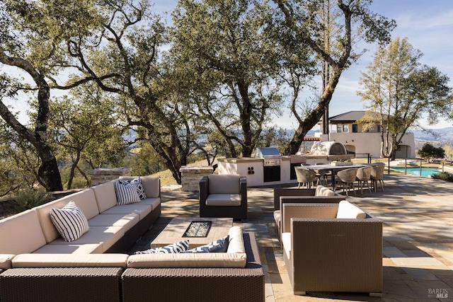 view of patio with an outdoor living space, area for grilling, outdoor dining area, and an outdoor pool