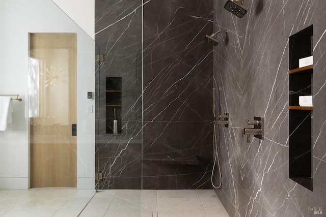 bathroom featuring a marble finish shower