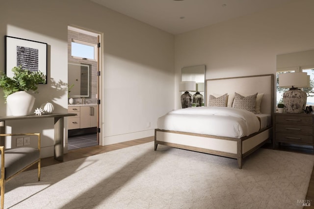 bedroom with a sink, baseboards, and ensuite bath