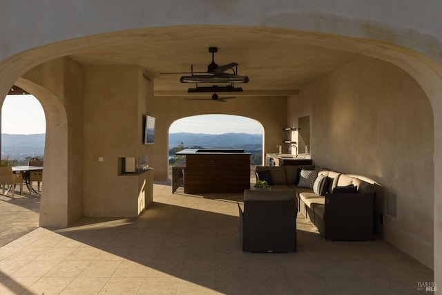 view of patio with a ceiling fan, a mountain view, and an outdoor hangout area