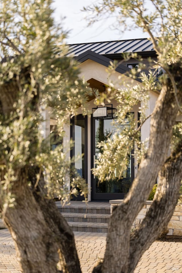 view of side of home with a standing seam roof and metal roof