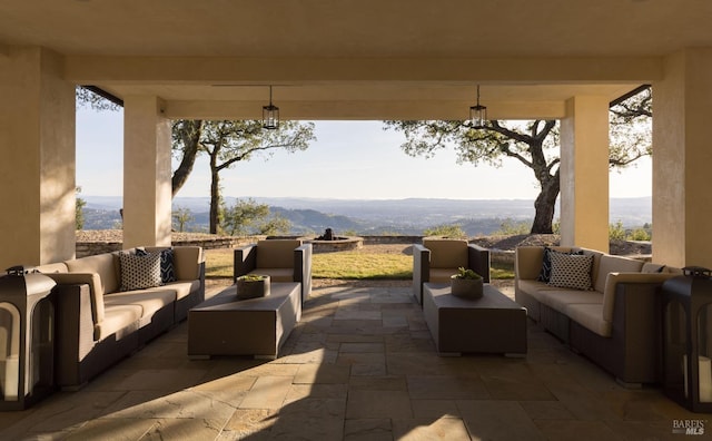 view of patio with an outdoor living space and a mountain view