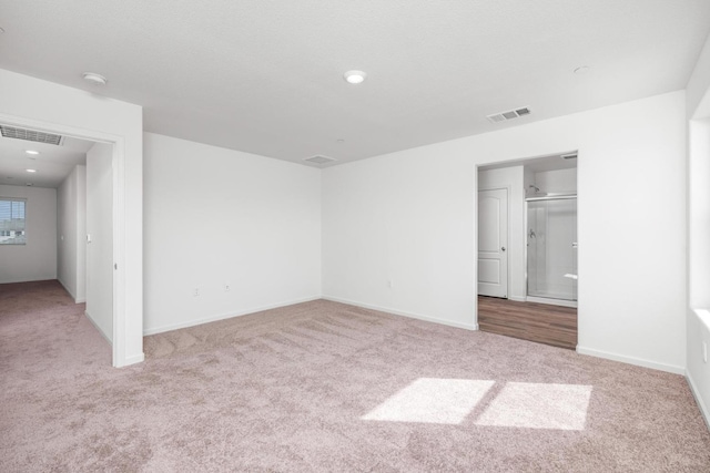 unfurnished bedroom with baseboards, visible vents, recessed lighting, and carpet flooring