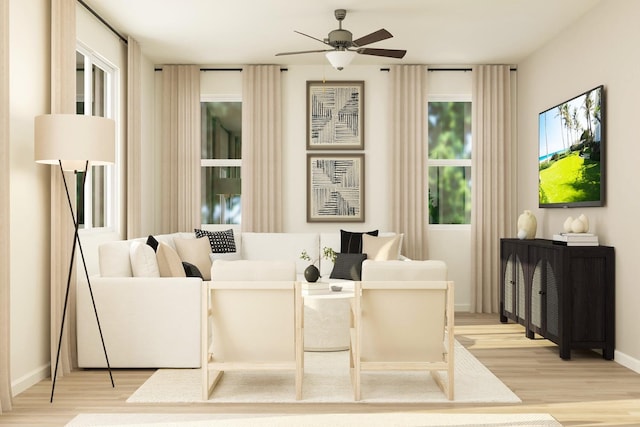 living area with light wood-type flooring, baseboards, and ceiling fan