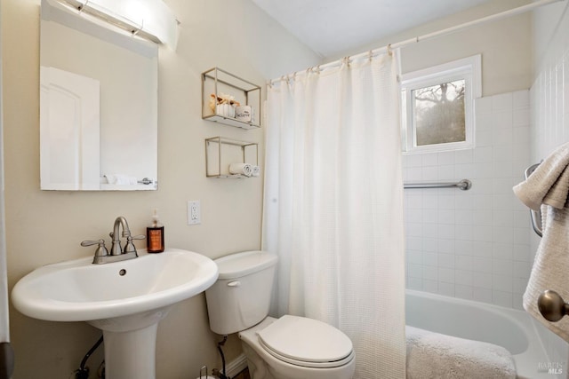 full bathroom with shower / tub combo, a sink, and toilet