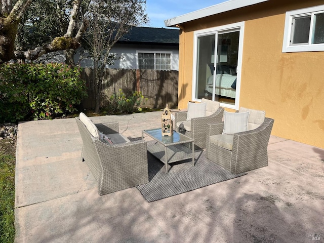 view of patio / terrace featuring fence and an outdoor hangout area