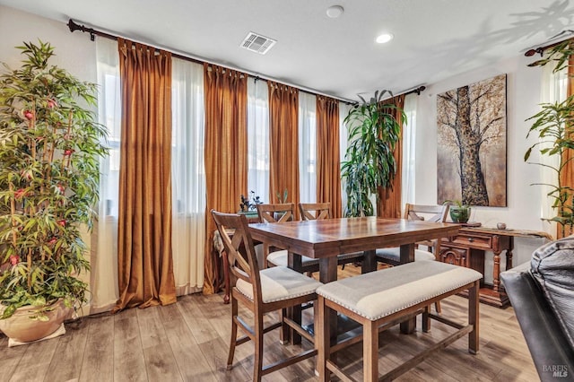 dining space featuring light wood finished floors, visible vents, and recessed lighting