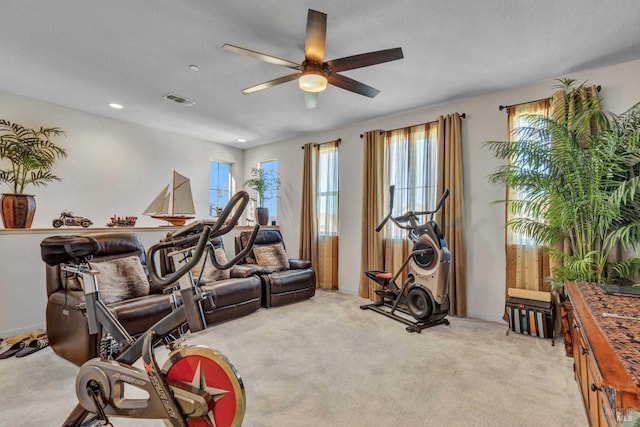 exercise area featuring recessed lighting, visible vents, light carpet, and ceiling fan