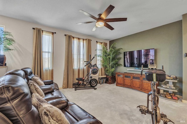 carpeted living room with ceiling fan