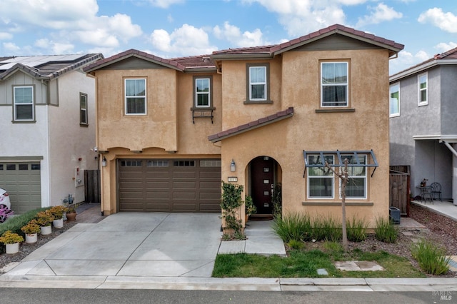 view of front of property with a garage, a tile roof, driveway, and stucco siding