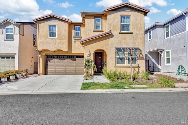view of front of house featuring stucco siding, a tiled roof, concrete driveway, and a garage