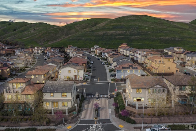 aerial view at dusk with a mountain view and a residential view