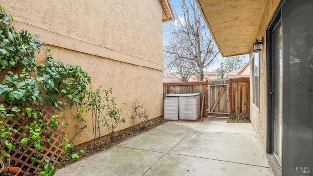 view of patio featuring a gate and fence