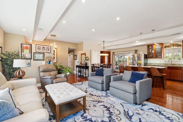 living room featuring light wood-style flooring, recessed lighting, and visible vents