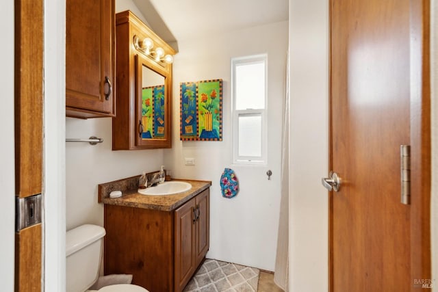 bathroom with toilet and vanity