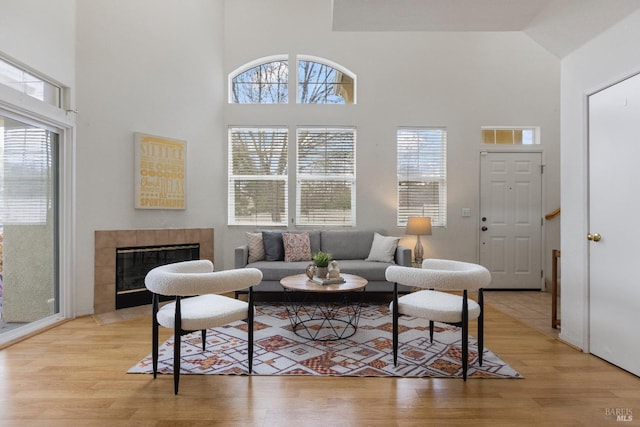 330 Windward Cmn Unit 4, Livermore, CA 94551 - living area featuring a towering ceiling, light wood-style flooring, and a tiled fireplace