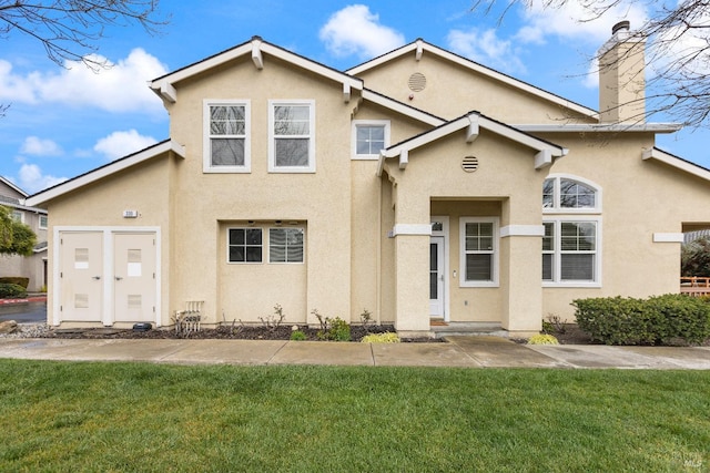 330 Windward Cmn Unit 4, Livermore, CA 94551 - view of front of property with a front lawn, a chimney, and stucco siding