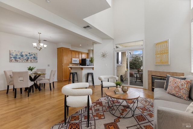 330 Windward Cmn Unit 4, Livermore, CA 94551 - living area with a chandelier, light wood-style flooring, and a fireplace