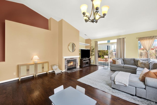 living room featuring baseboards, a chandelier, high vaulted ceiling, wood finished floors, and a fireplace