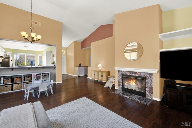 living room featuring wood finished floors, visible vents, a fireplace, a chandelier, and high vaulted ceiling
