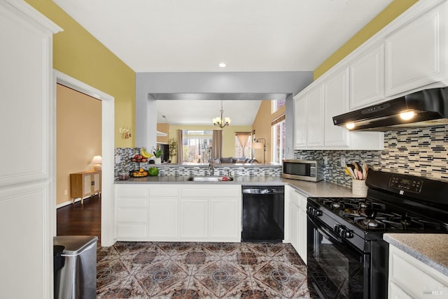 kitchen with under cabinet range hood, an inviting chandelier, a sink, decorative backsplash, and black appliances