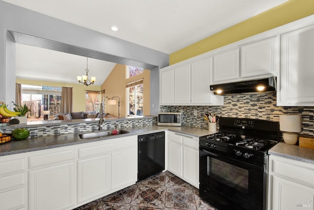 kitchen featuring black appliances, under cabinet range hood, tasteful backsplash, and a sink