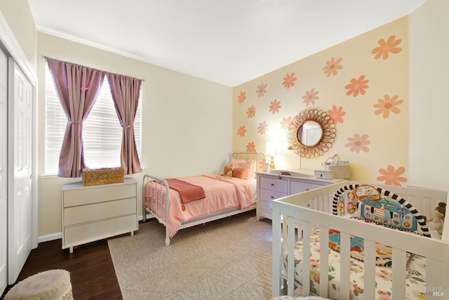 bedroom with wallpapered walls, wood finished floors, and baseboards