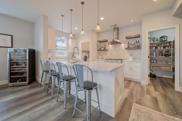 3982 Lucero St, Napa, CA 94558 - kitchen with beverage cooler, ventilation hood, white cabinets, open shelves, and a peninsula