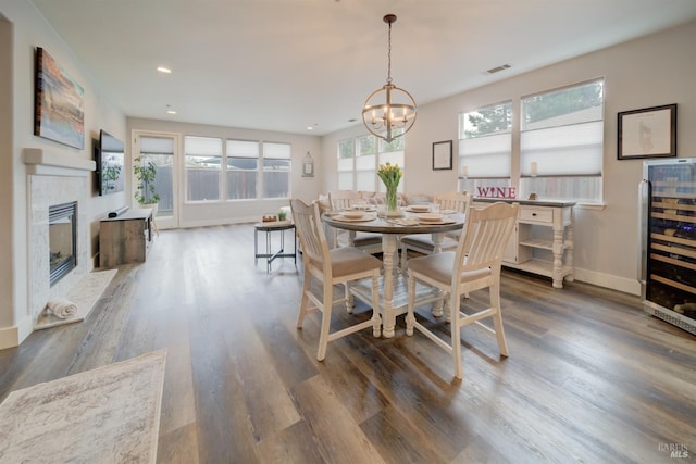 3982 Lucero St, Napa, CA 94558 - dining room featuring wood finished floors, a chandelier, wine cooler, recessed lighting, and a glass covered fireplace