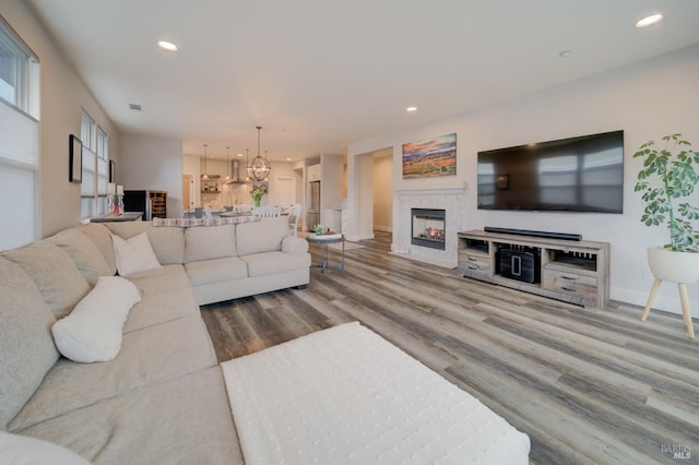 3982 Lucero St, Napa, CA 94558 - living area featuring wood finished floors, recessed lighting, a warm lit fireplace, a chandelier, and baseboards