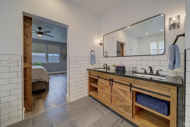3982 Lucero St, Napa, CA 94558 - ensuite bathroom featuring double vanity, healthy amount of natural light, tile walls, a ceiling fan, and tile patterned floors