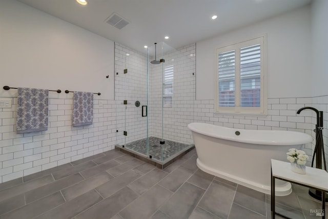 3982 Lucero St, Napa, CA 94558 - bathroom featuring tile walls, a shower stall, a soaking tub, recessed lighting, and tile patterned floors