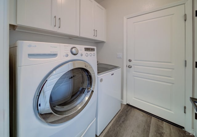 3982 Lucero St, Napa, CA 94558 - laundry room featuring washer and dryer, wood finished floors, and cabinet space