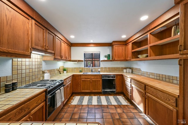 kitchen with open shelves, a sink, tile countertops, decorative backsplash, and black appliances