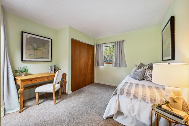 carpeted bedroom with baseboards and a closet