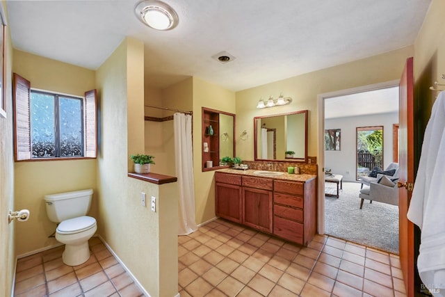 full bathroom featuring vanity, tile patterned flooring, baseboards, and toilet