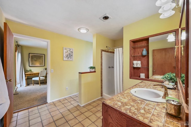 bathroom with tile patterned floors, baseboards, vanity, and curtained shower