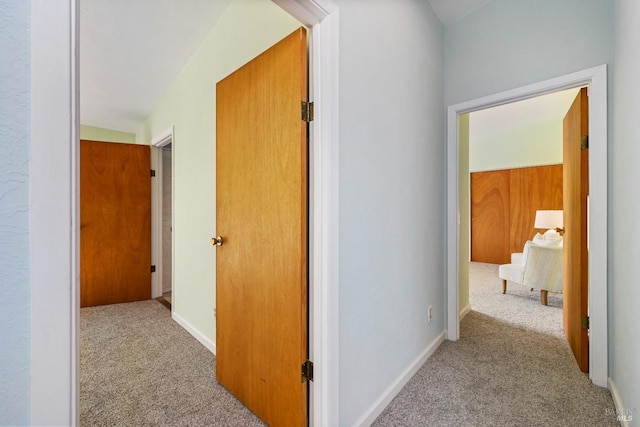 hallway with baseboards and carpet