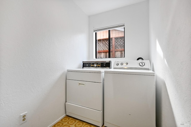 laundry room with laundry area, baseboards, and washing machine and dryer