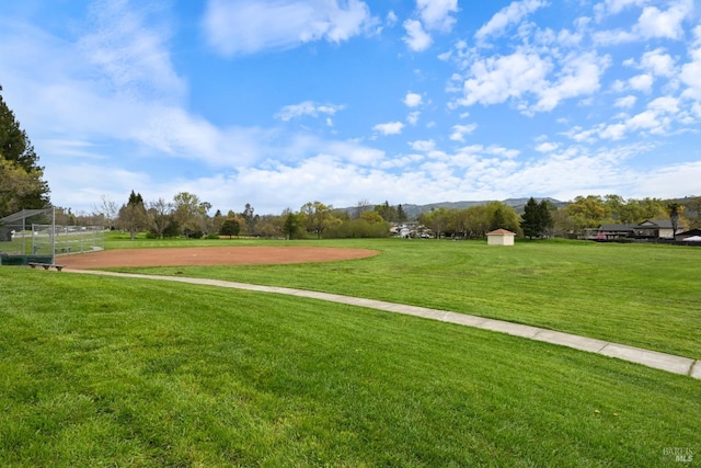view of community with a lawn and a mountain view