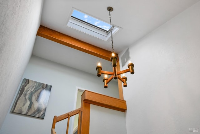 room details featuring a skylight, a chandelier, and visible vents