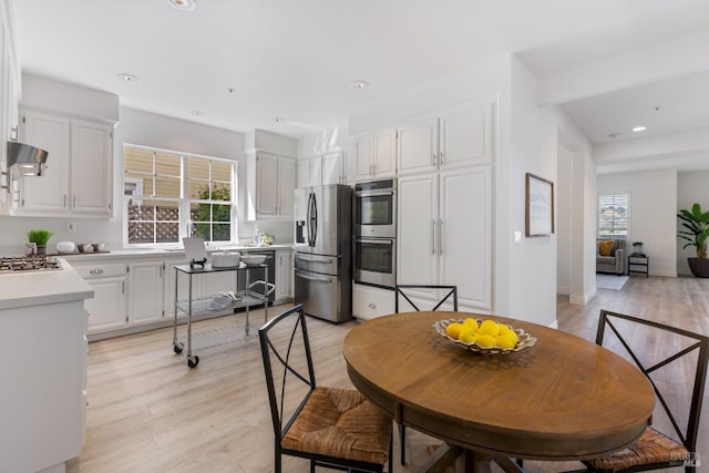 dining area with recessed lighting and light wood-style flooring