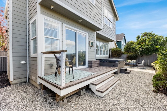 deck with fence and a hot tub