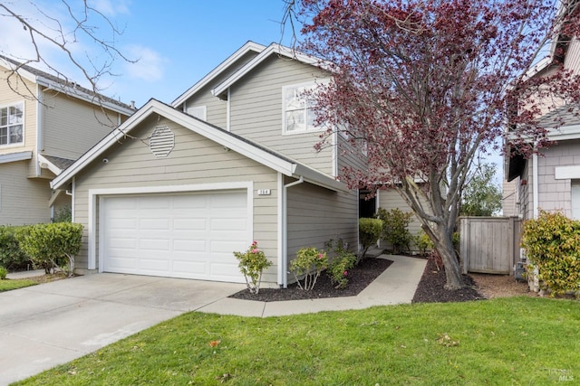 view of front of home with an attached garage, a front yard, concrete driveway, and fence