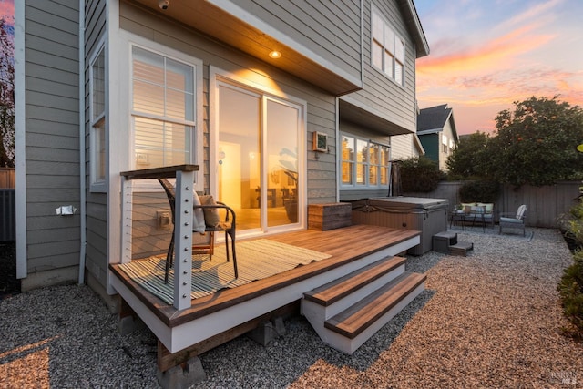 wooden deck with fence and a hot tub