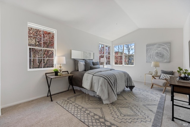 bedroom featuring baseboards, lofted ceiling, and light colored carpet