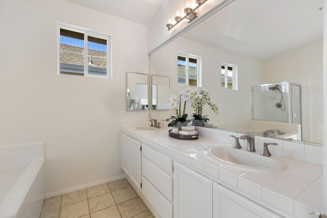 bathroom with a stall shower, a sink, and a healthy amount of sunlight
