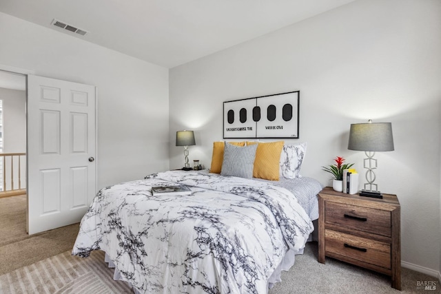 carpeted bedroom featuring visible vents